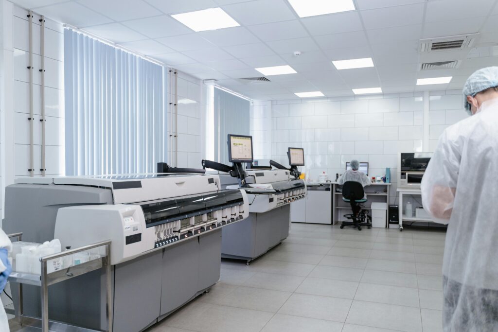 Bright and sterile laboratory featuring high-tech research equipment and professionals at work.